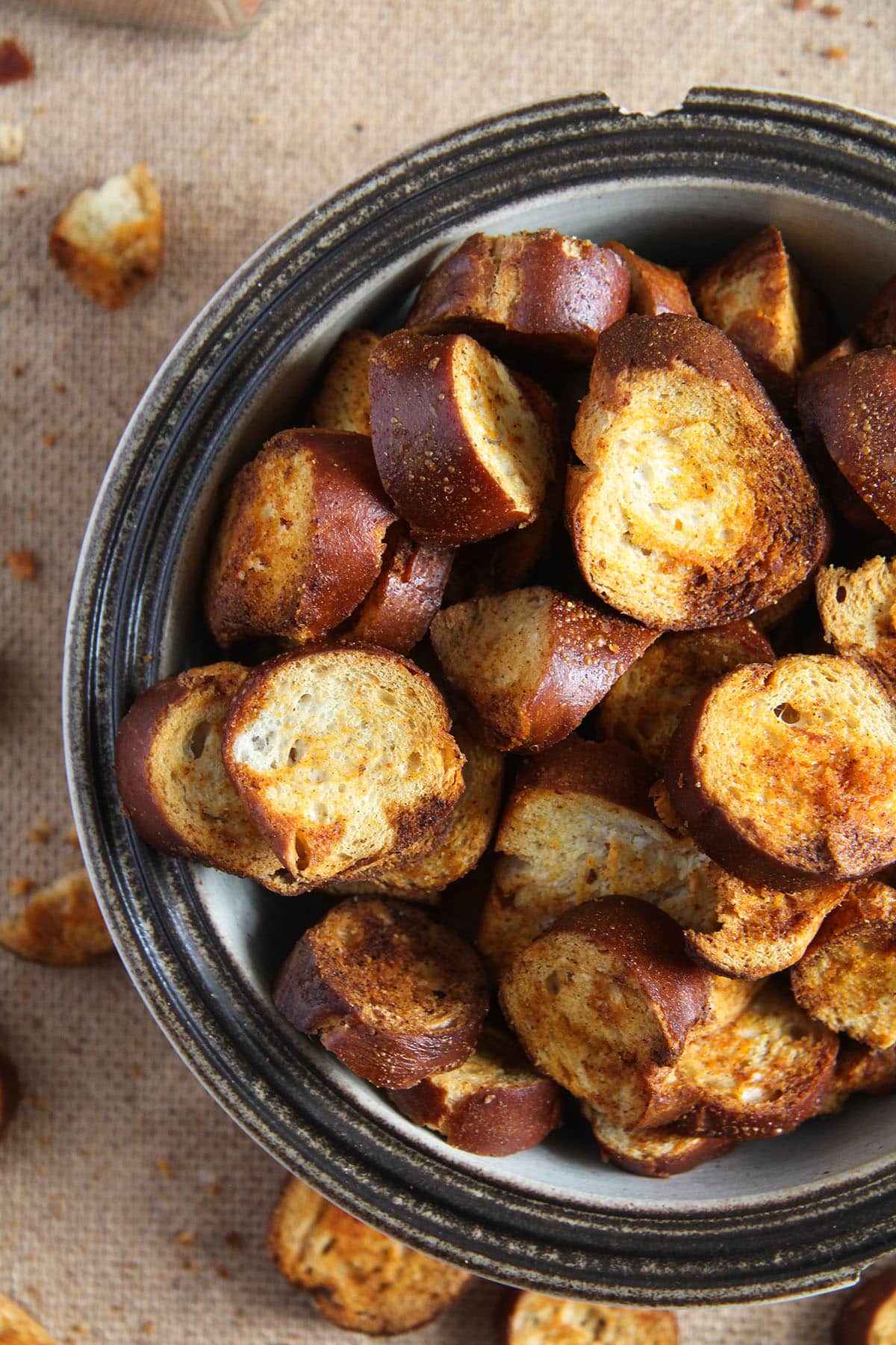 crispy and spicy chips made from day-old preztels in a chipped bowl.