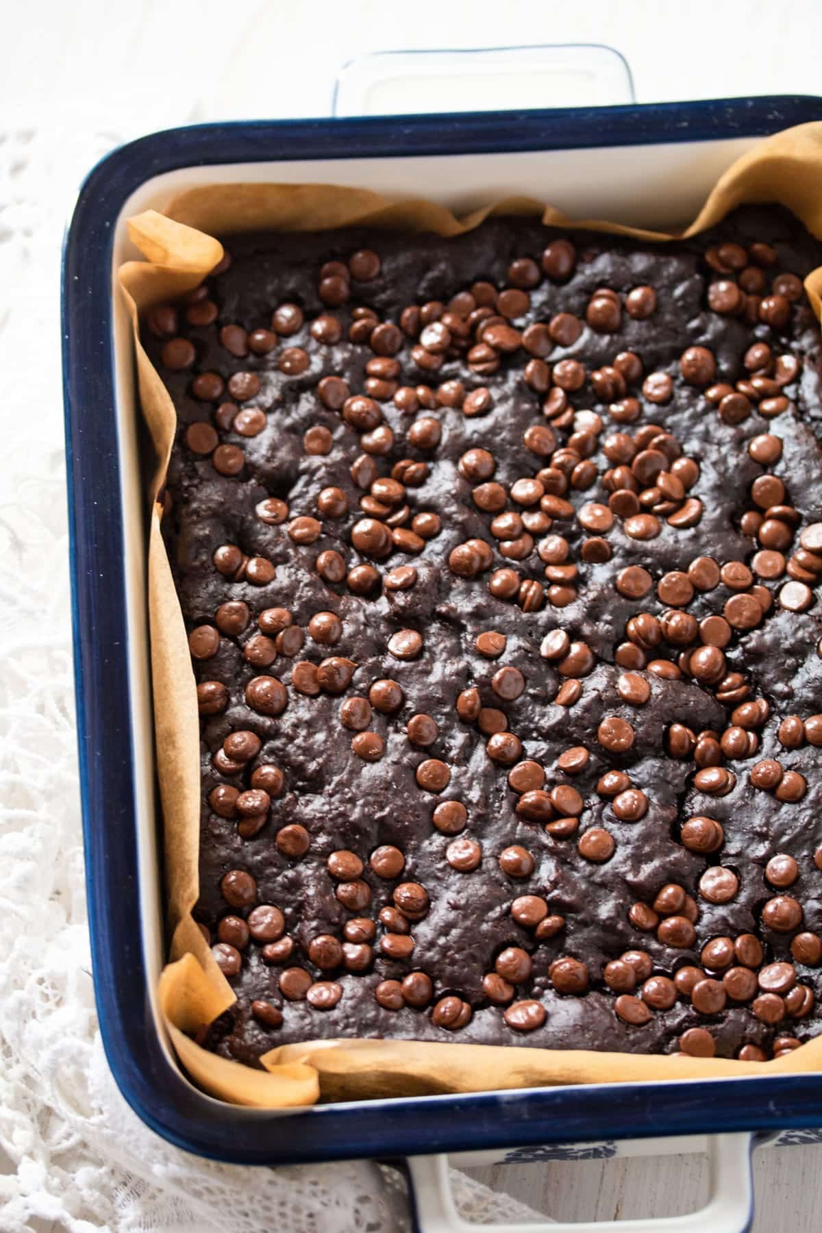 black bean brownies sprinkled with chocolate chips in a pan.