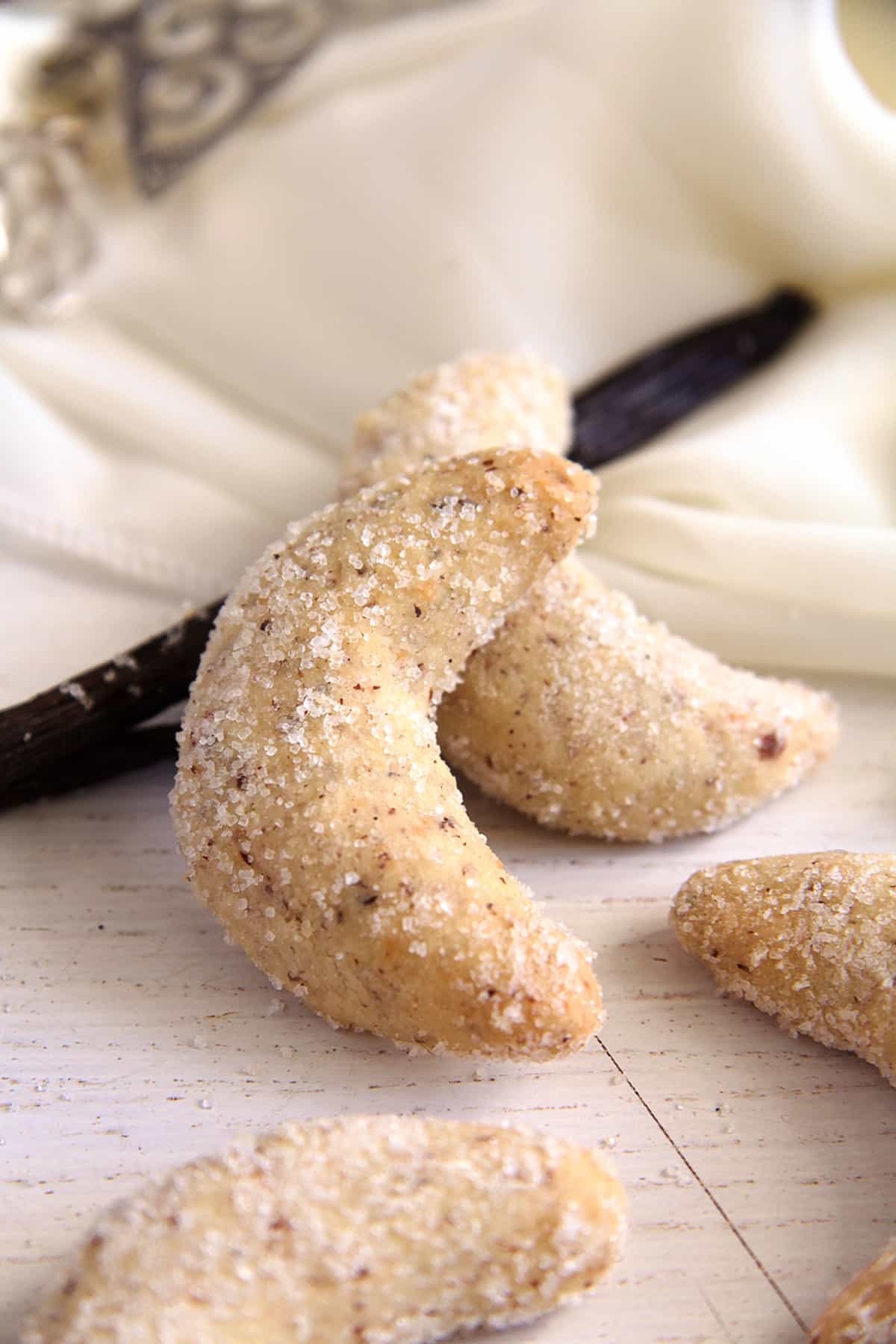 vanillekipferl covered in vanilla sugar and a vanilla pod.