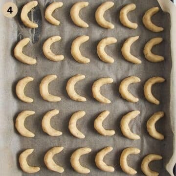 unbaked vanillekipferl on a baking sheet.