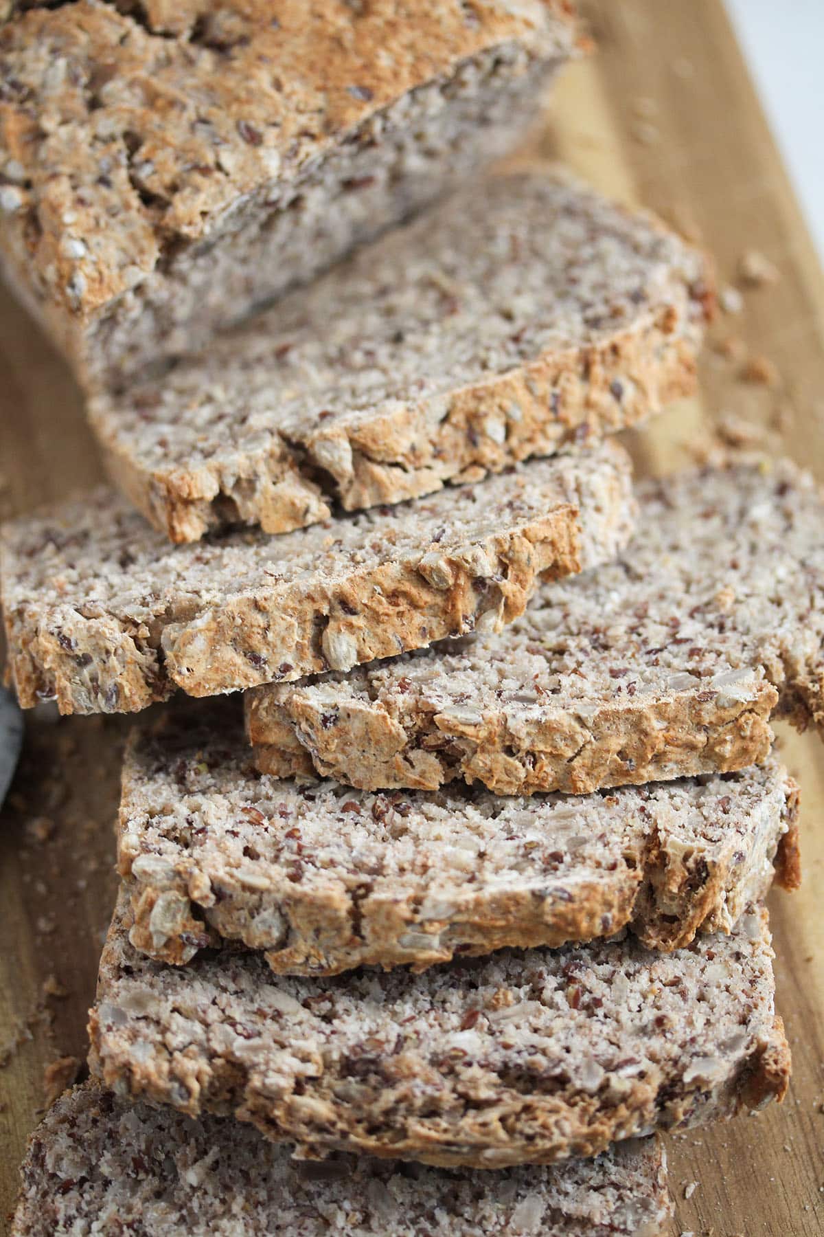 sliced buckwheat bread on a wooden cutting board.