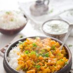 bowl of cauliflower curry with rice pinterest image.