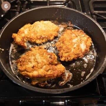 frying chicken breast in pancake batter in a pan.