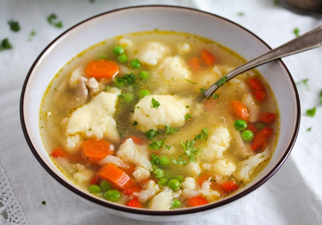 potato dumpling soup in a white bowl 