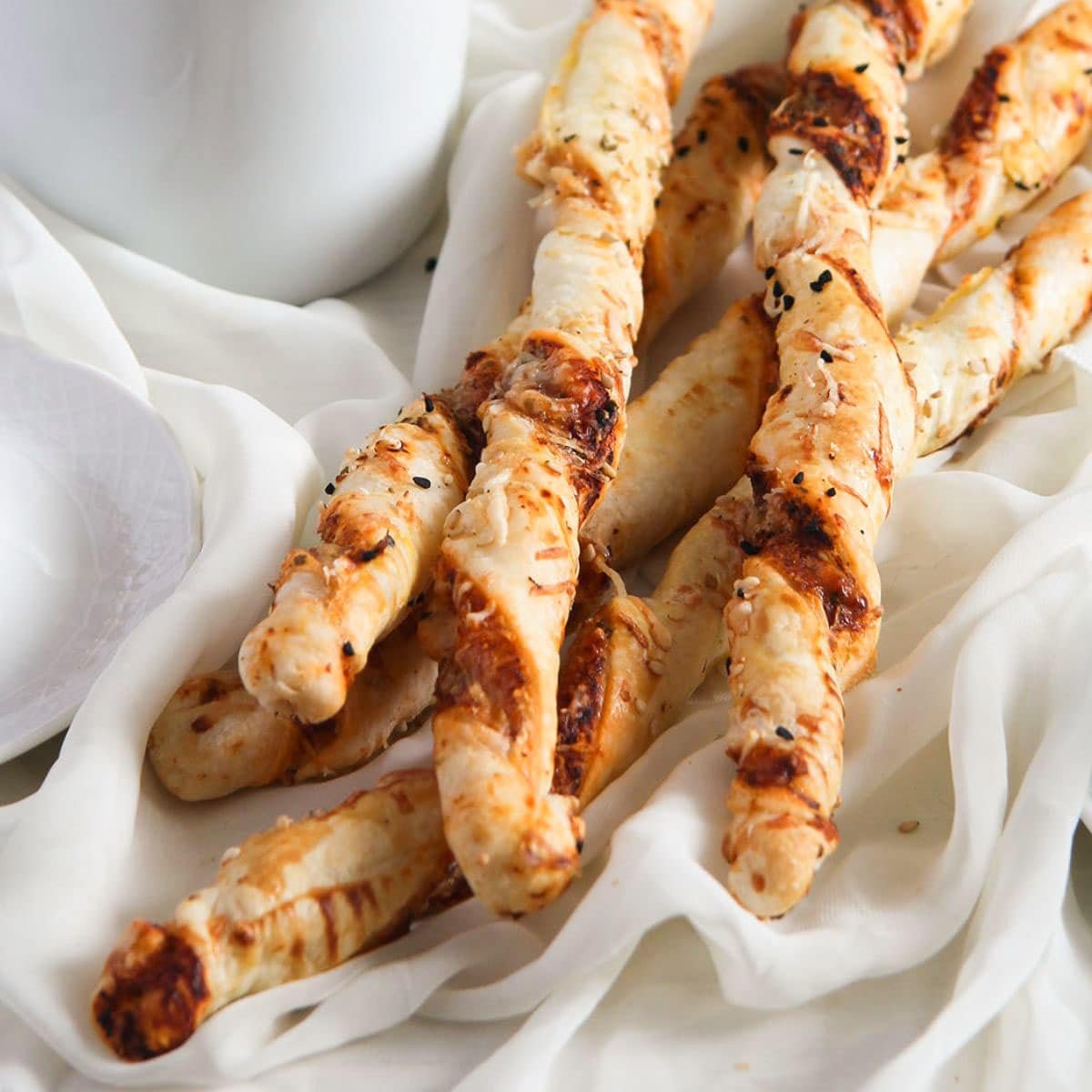 puff pastry pizza twists on a fine white cloth.