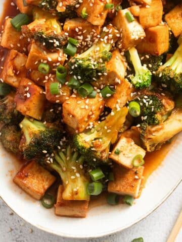sweet and sour broccoli close up on a platter with chopsticks,