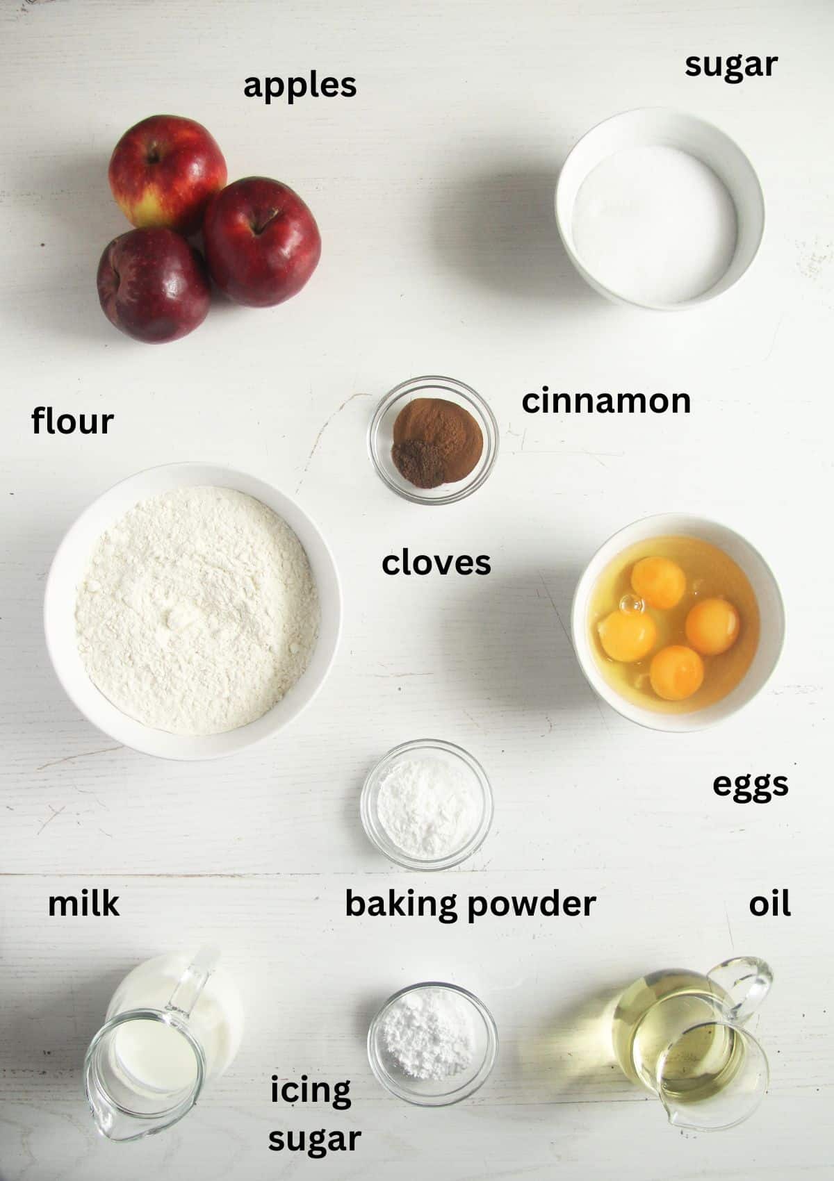 listed ingredients in bowls for making stewed apple cake.