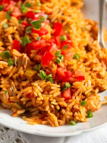 bbq rice topped with diced tomatoes and chopped parsley.