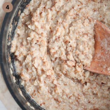 stirring creamy buckwheat porridge with a wooden spoon.