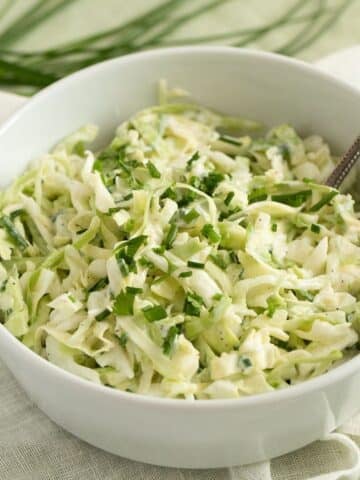 german coleslaw with parsley in a bowl.