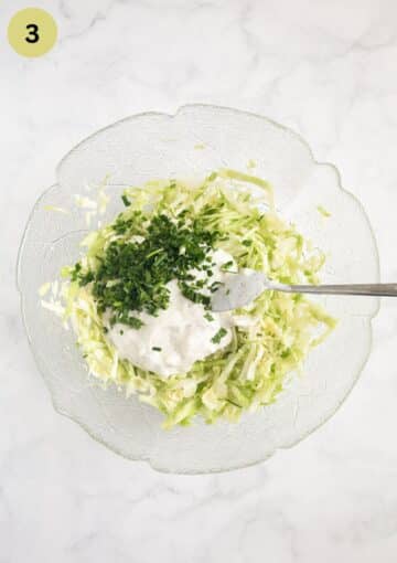 shredded salad, soiur cream and herbs in a bowl before mixing them for salad.