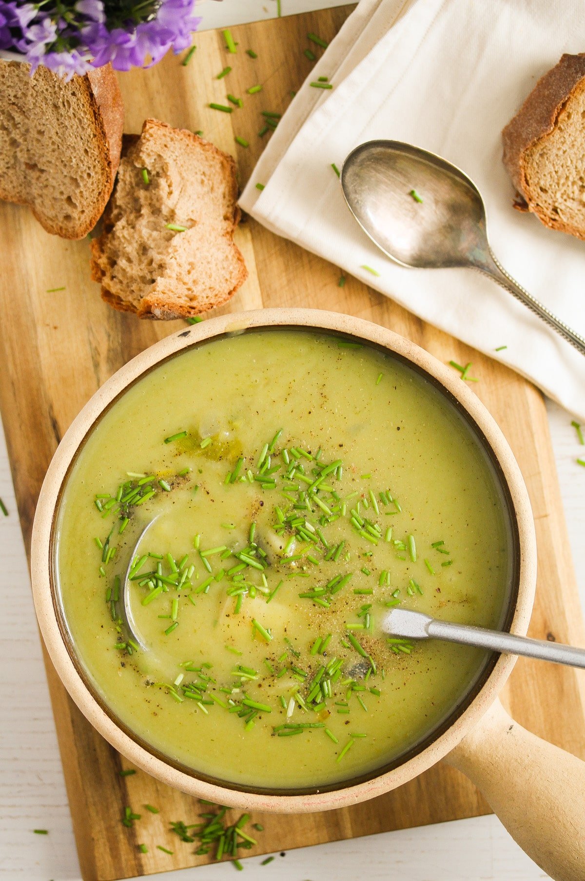 green soup with bread on the table
