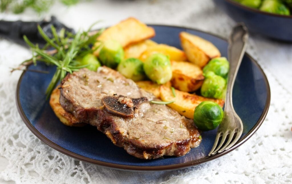 baked lamb chops and potatoes with sprouts