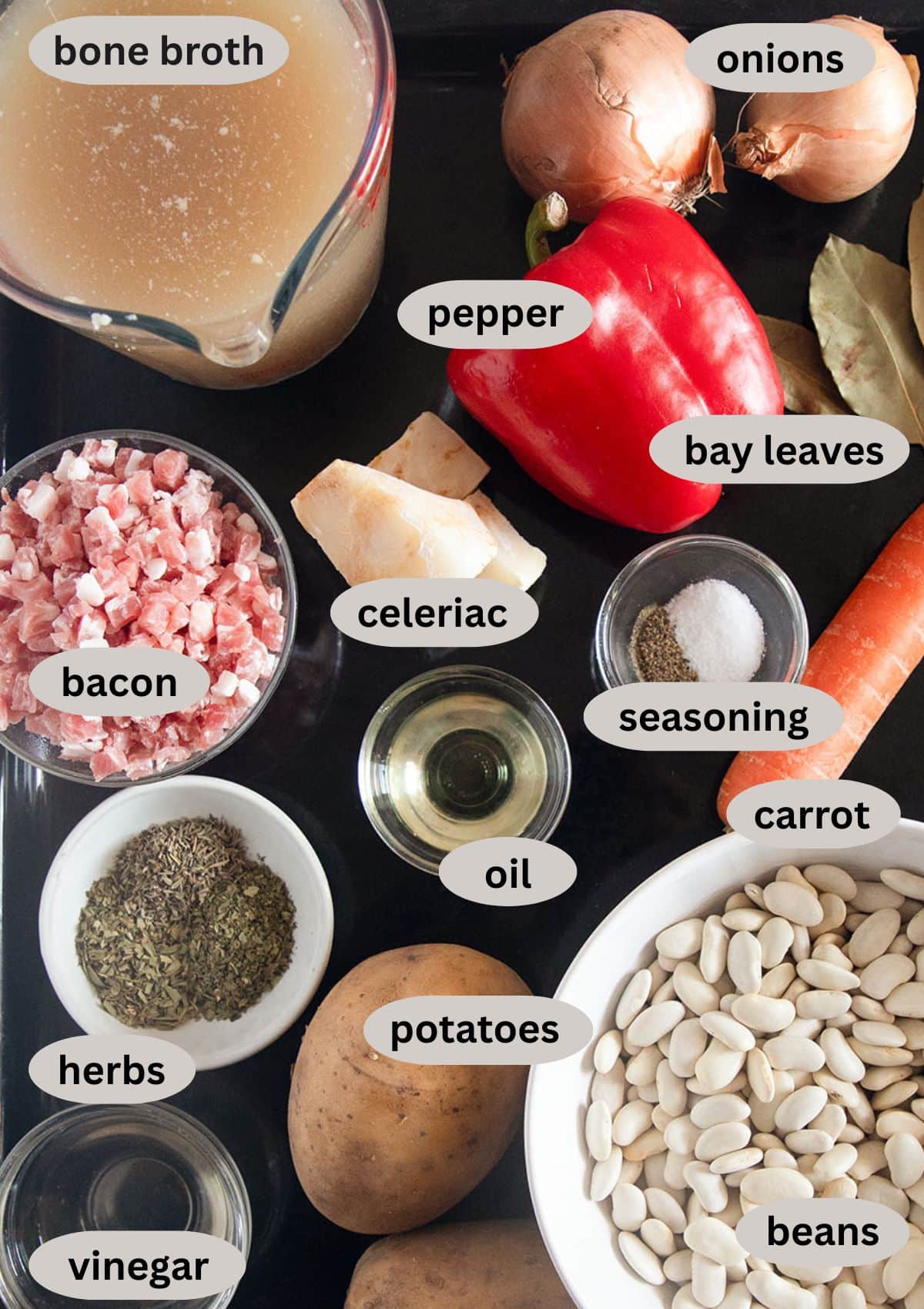 labeled ingredients for making bone broth soup with vegetables.