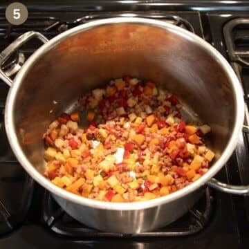 sauteing bacon and veggies to make soup in a pot.