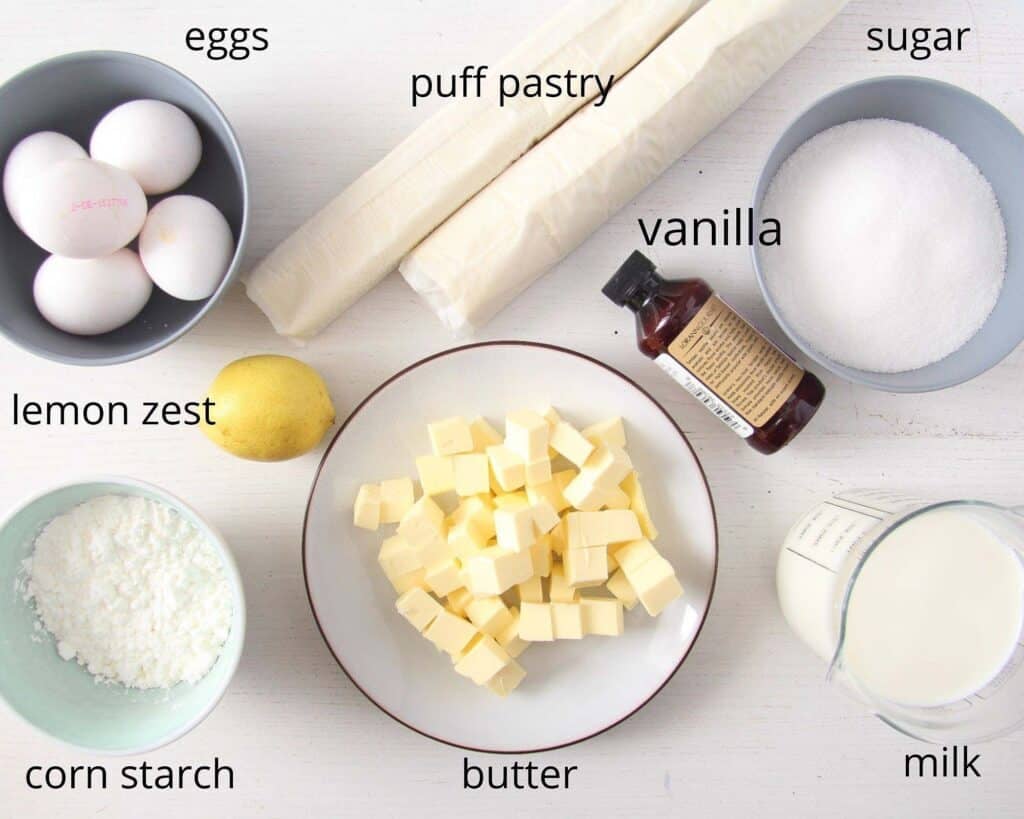 eggs, puff pastry rolls, sugar, butter, milk and cornstarch in bowls