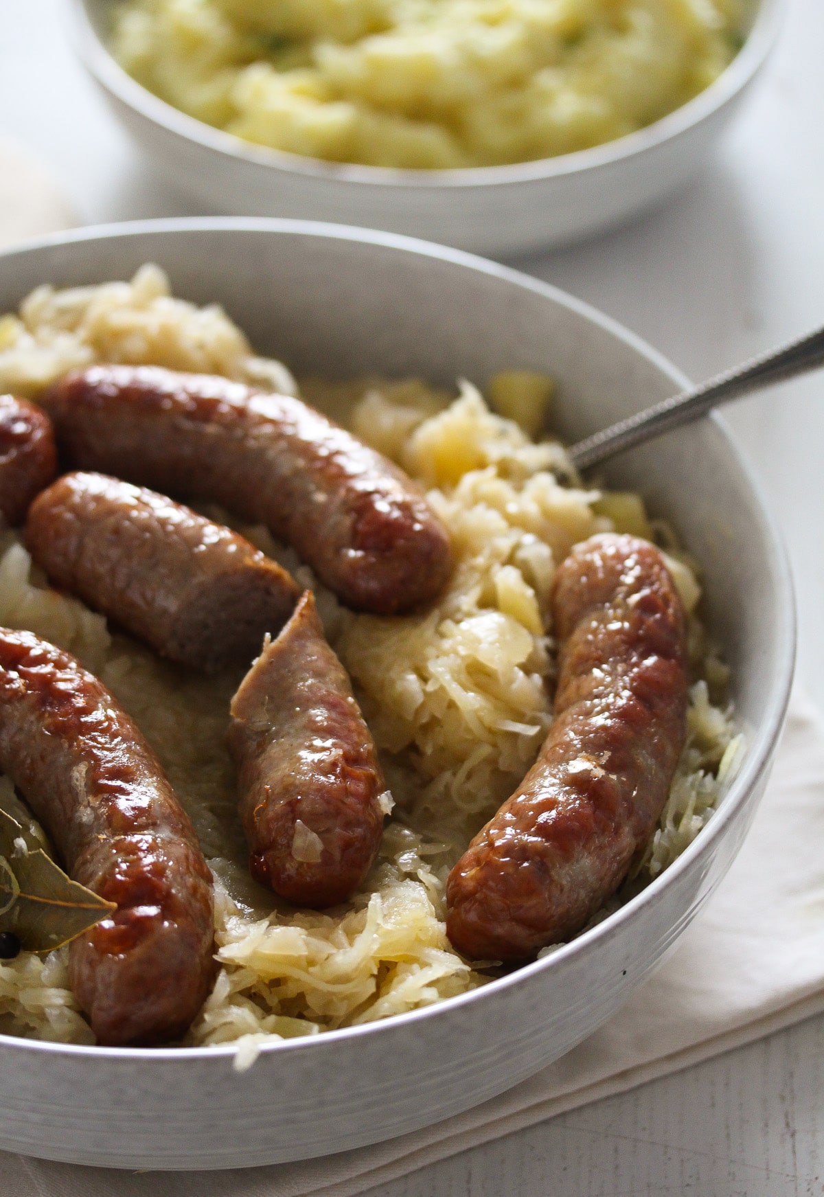 bratwurst cooked in oven and served on sauerkraut