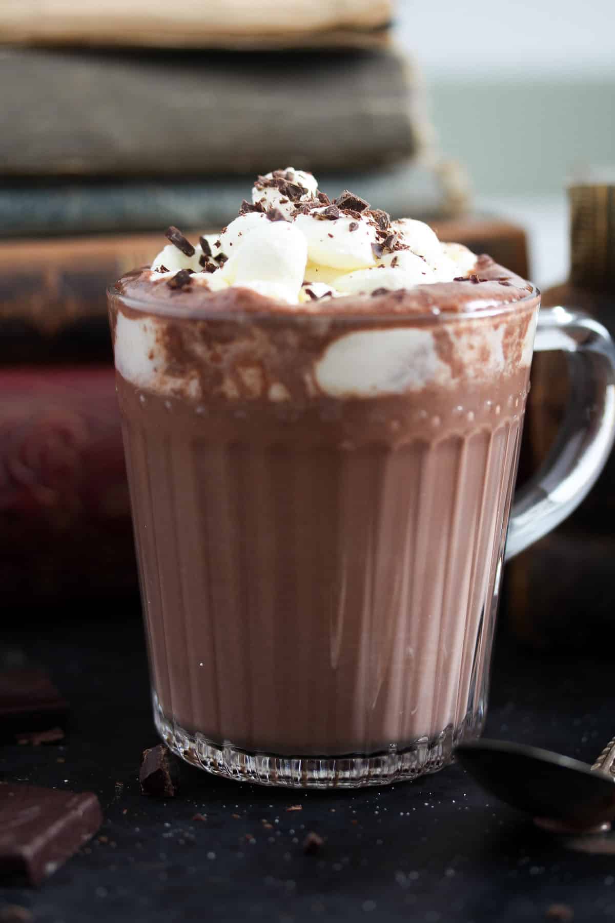 a cup with irish cream hot chocolate topped with whipped cream and chocolate shavings.