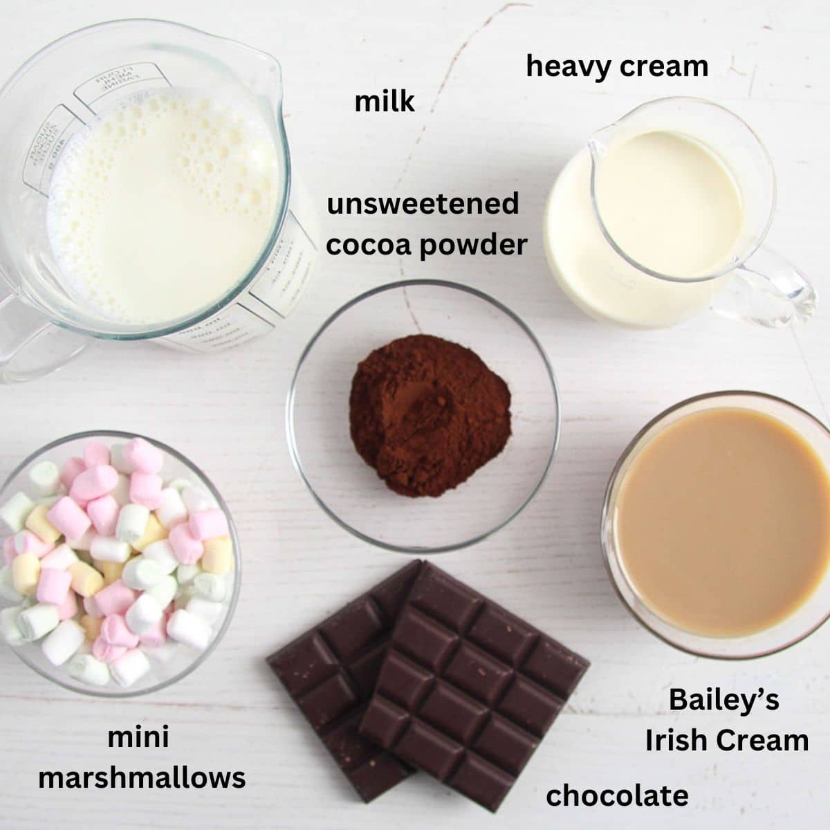listed ingredients for making hot chocolate with irish cream, marshmallows, chocolate, and cocoa.