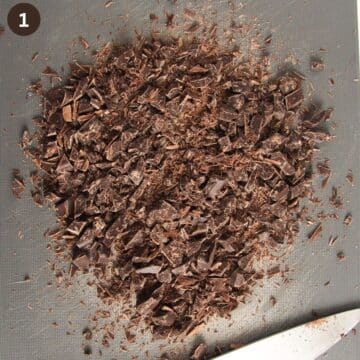 finely chopped dark chocolate on a gray cutting board.