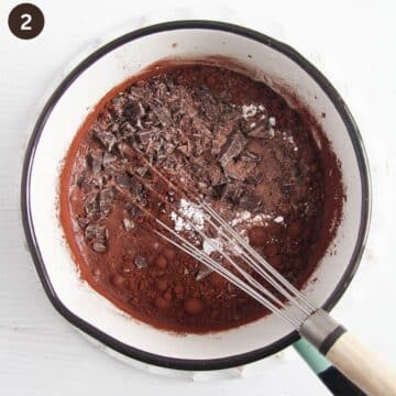 whisking chopped chocolate to melt it in a saucepan with cream and milk.