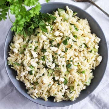 lemon orzo salad with feta and herbs in a large bowl.