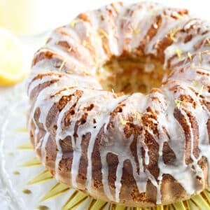 limoncello bundt cake drizzled with glaze on a cake platter.