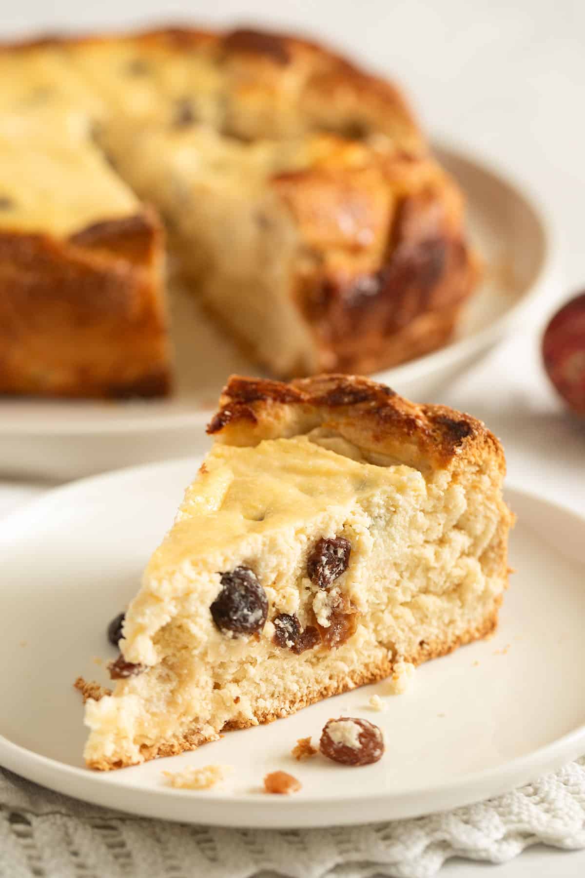 Pasca cheesecake with a slice cut to show the cheese filling inside.