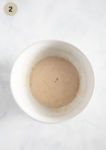yeast, flour, and milk mixture in a small bowl.
