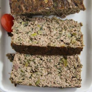 thickly sliced romanian drob on a serving platter.