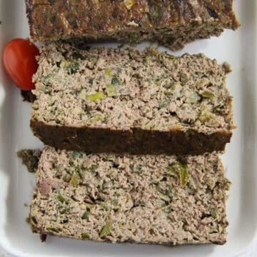 thickly sliced romanian drob on a serving platter.