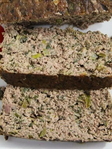 thickly sliced romanian drob on a serving platter.