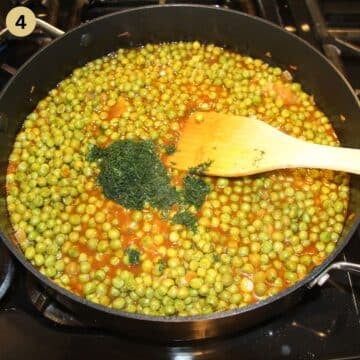 stirring chopped dill with a wooden spoon in a pot full of pea stew.
