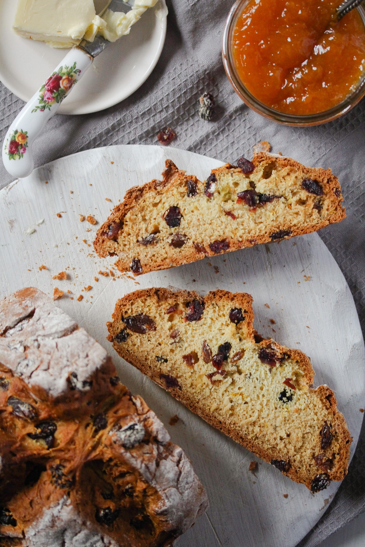 two slices of raisin bread and a jar of apricot jam