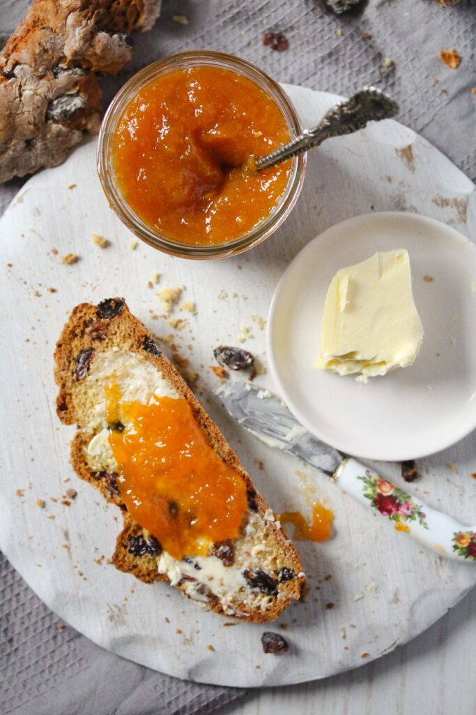 slice of buttered bread with apricot jam