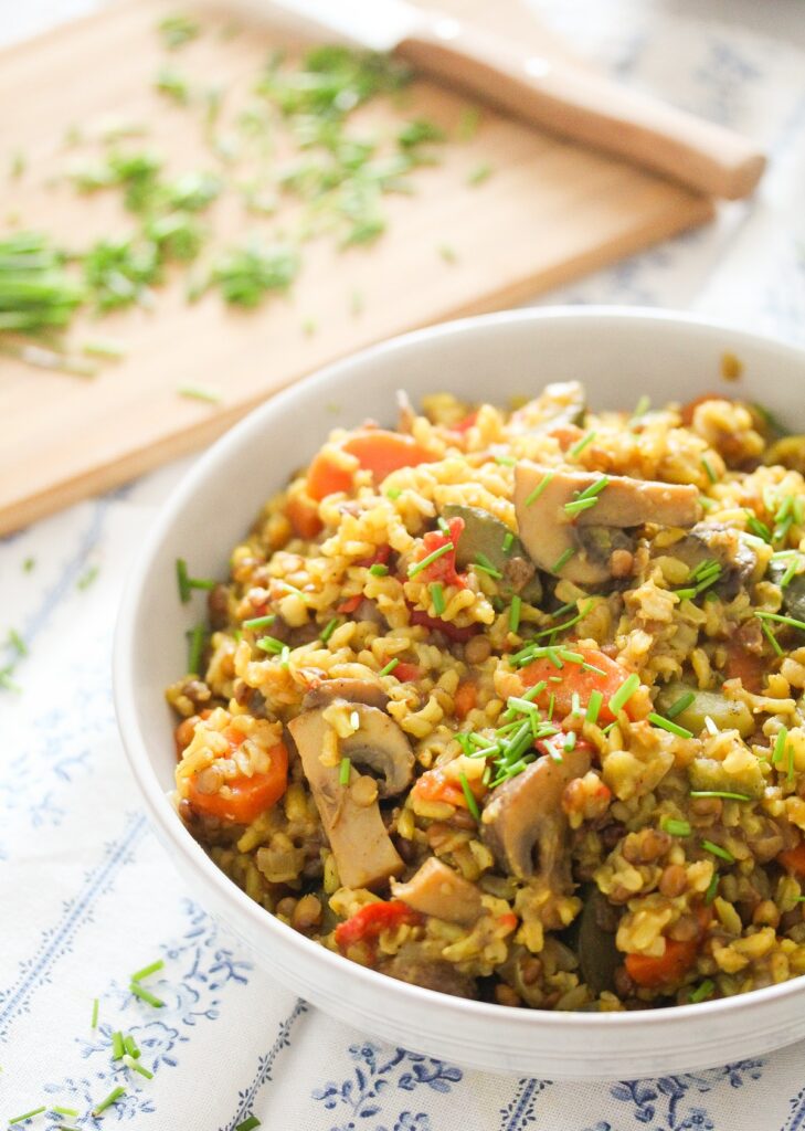 lentils and rice in a white bowl with chives