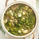 asparagus chicken soup with noodles in a large bowl.