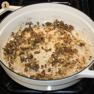 sauteed onions and spices in a dutch oven for making curry with asparagus.