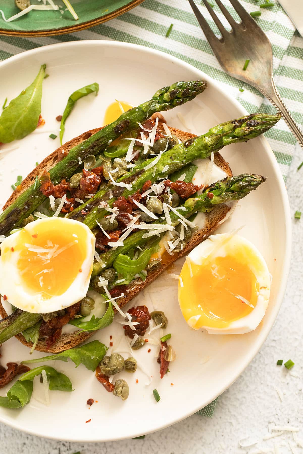 asparagus and a halved soft boiled egg on toast. 