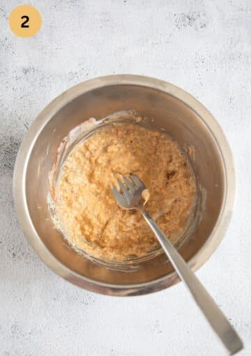 mixing crushed egg yolks with mayo and mustard in a bowl.