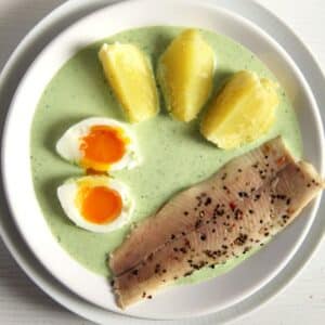 traditional german frankfurter sauce served with boiled eggs, potatoes, and smoked trout.