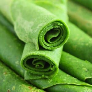 many rolled green wild garlic crepes.