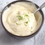 brown bowl of homemade mayo sprinkled with chives