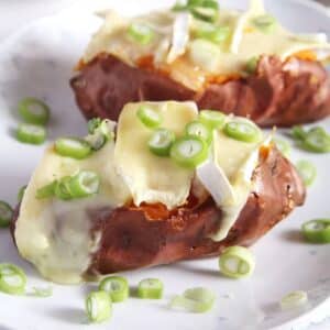 two jacket sweet potatoes stuffed with melty camembert and green onions.