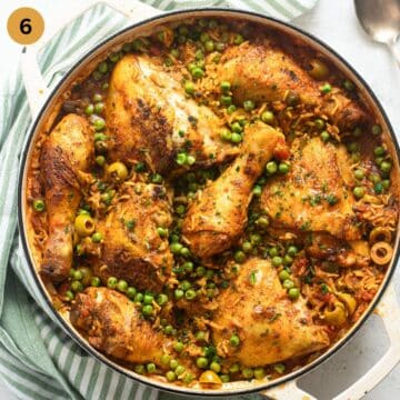 finished dish of rice with chicken and peas in a pot.