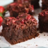 brownies with strawberries sliced on a table