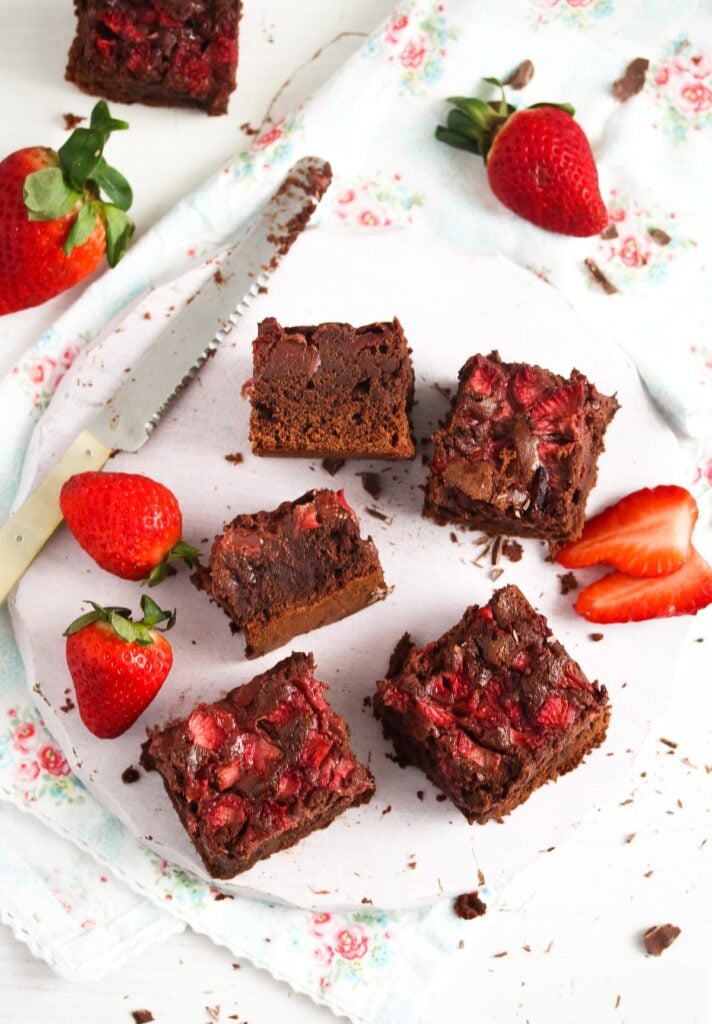 strawberries and brownies on a white wooden platter