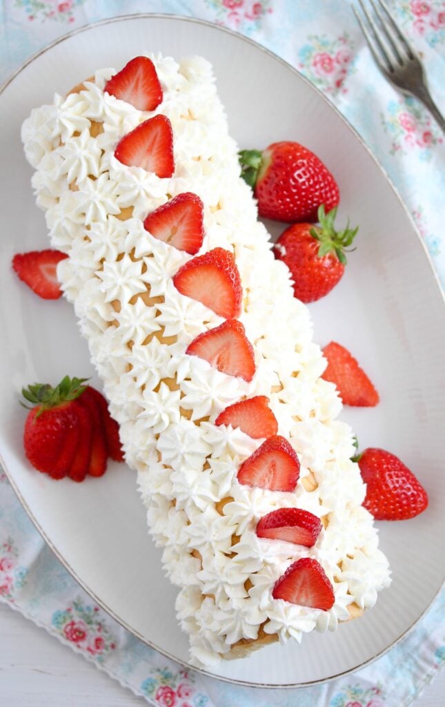 roulade with berries and piped with whipped cream