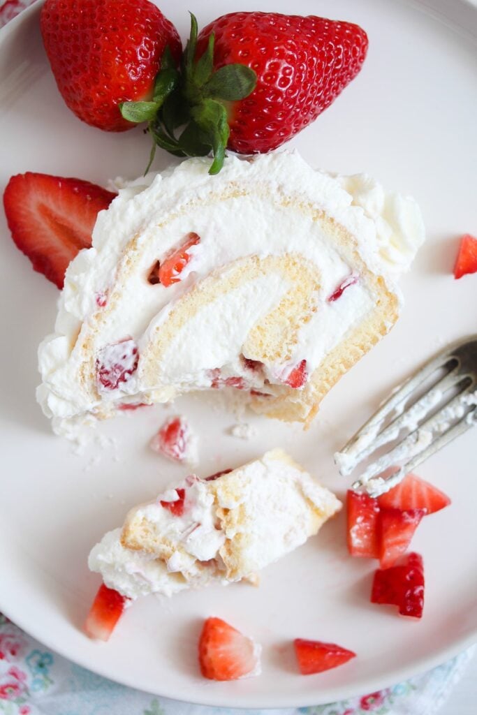 slice of strawberry cream roll eaten with a small fork