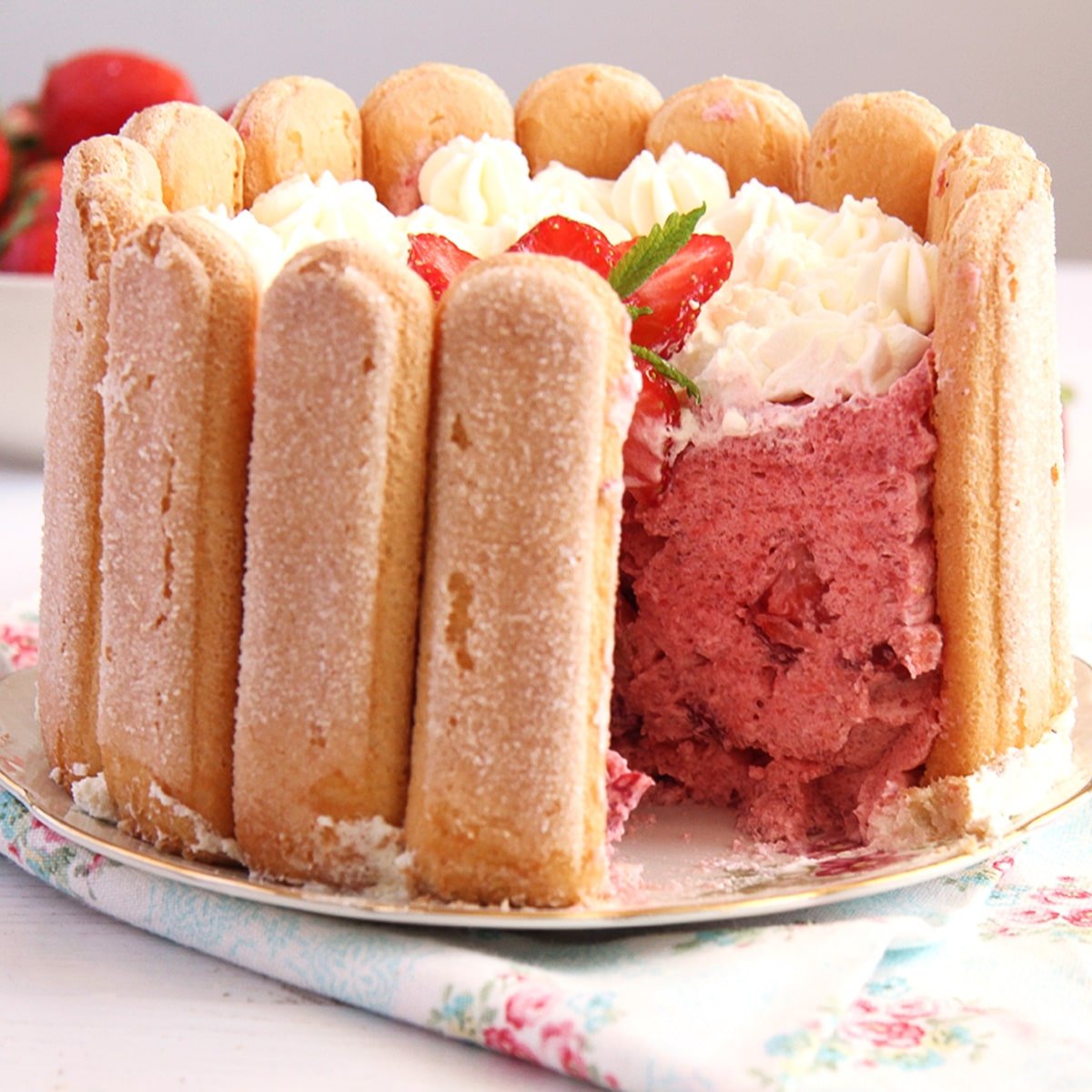 strawberry charlotte cut to show the mousse filling inside.